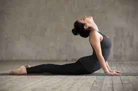 Cobra Pose (Bhujangasana) yoga pose to stimulate thyroid and strengthen the spine.